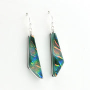 A pair of geometric drop earrings featuring iridescent green and blue dichroic glass set in silver, suspended from silver fishhook wires on a plain white background.