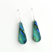 A pair of teardrop-shaped dangle earrings with silver fishhook wires and wrapped settings, featuring iridescent green, blue, and gold marbled glass pieces on a plain white background.