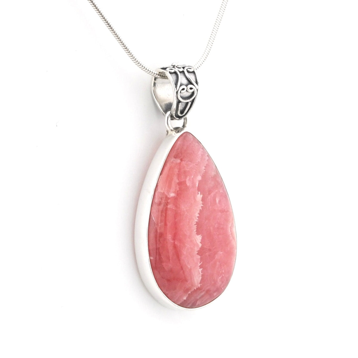 A teardrop-shaped pink gemstone pendant in a silver bezel setting on a silver chain, shown against a plain white background.