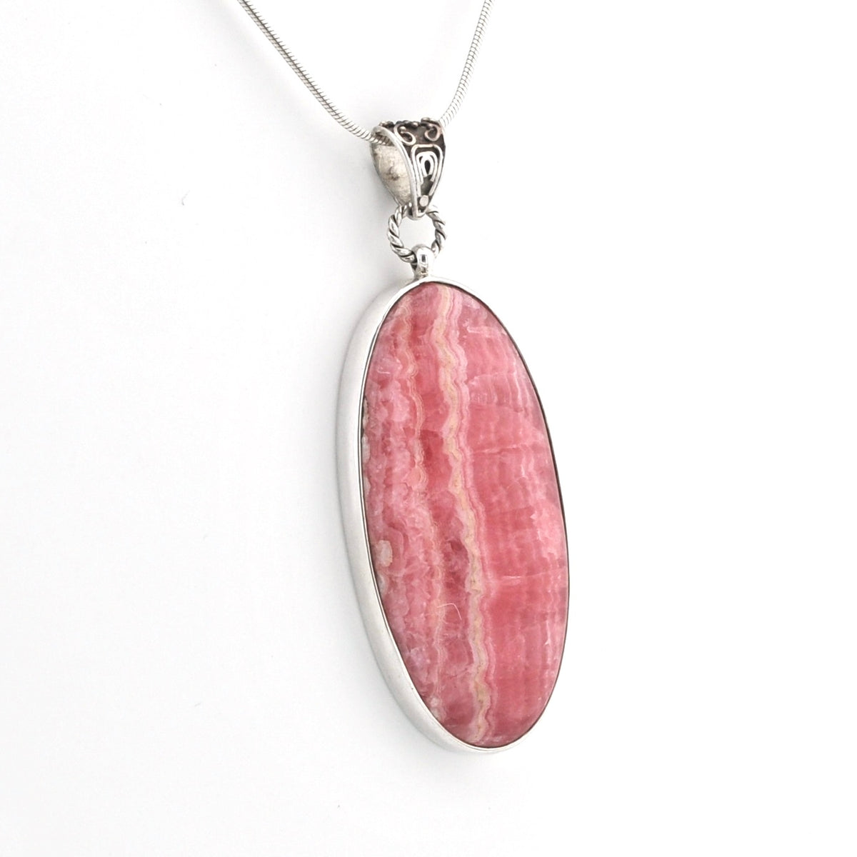 An oval pendant necklace featuring a pink and white banded stone, set in a polished silver bezel with a silver chain, shown against a plain white background.