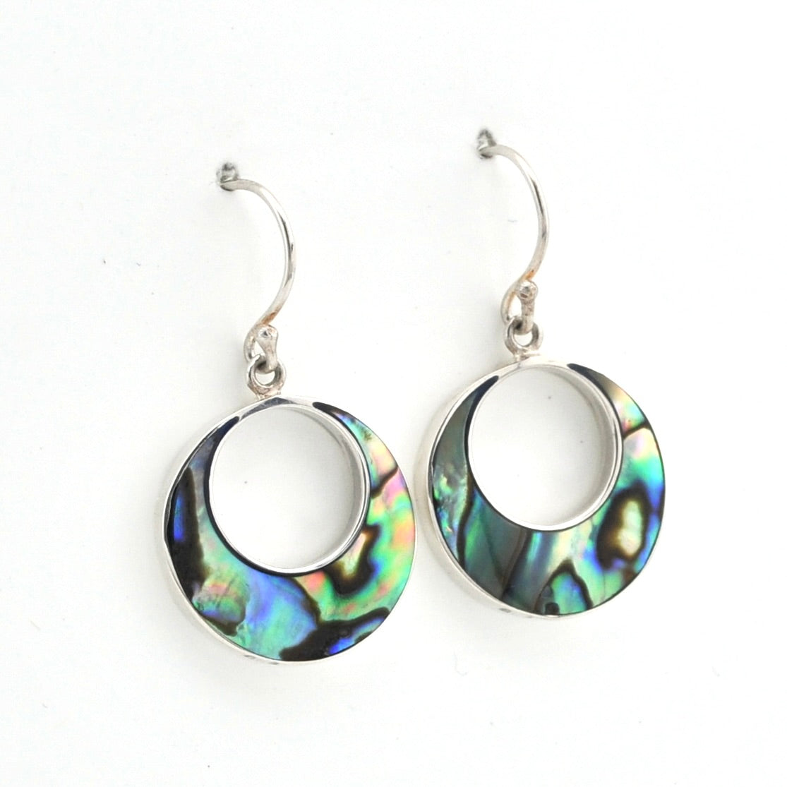 A pair of silver-toned hoop earrings with iridescent abalone shell inlays, displayed on a clean white background.
