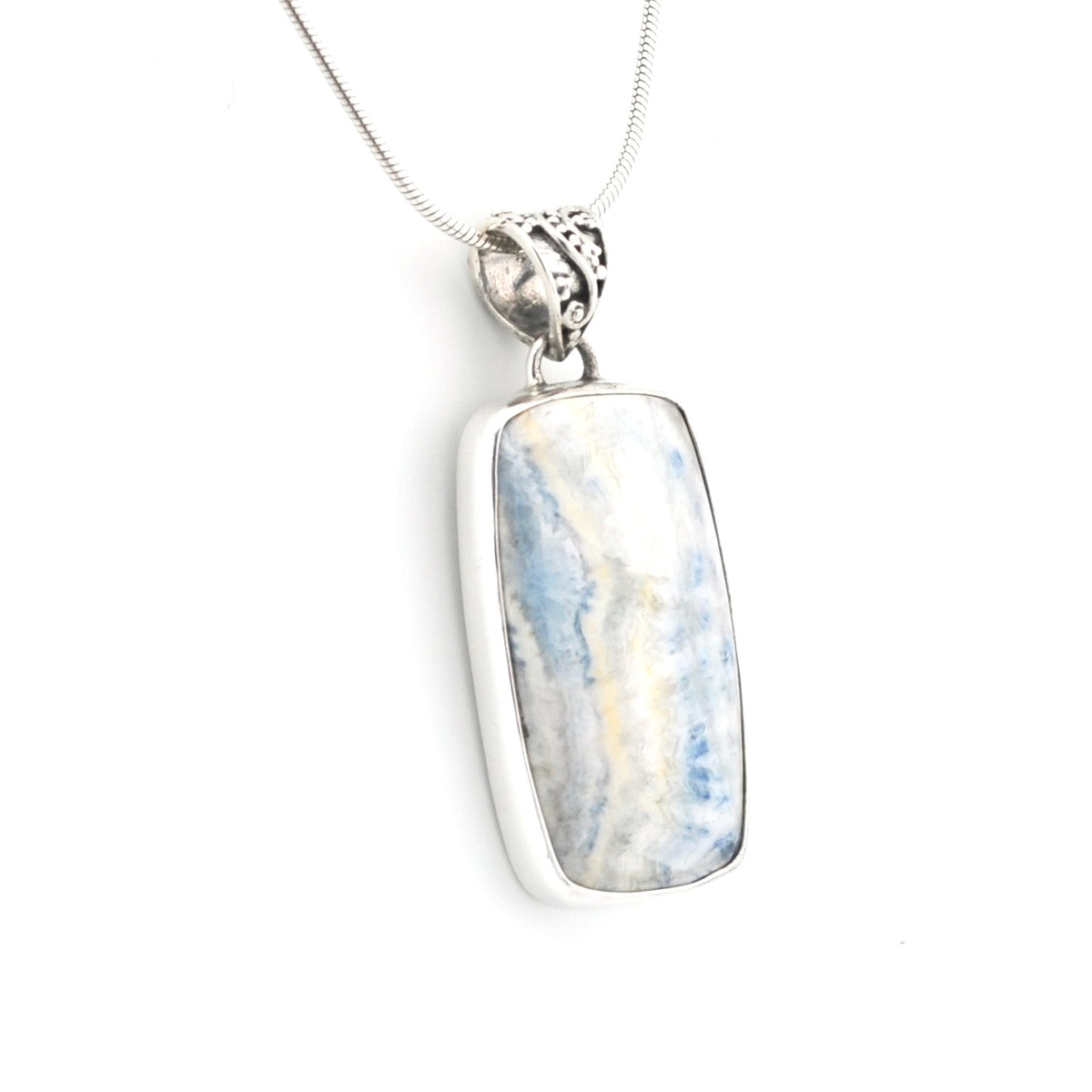 A silver rectangular pendant necklace featuring a polished blue and white marbled stone, suspended from a delicate silver chain against a plain white background.