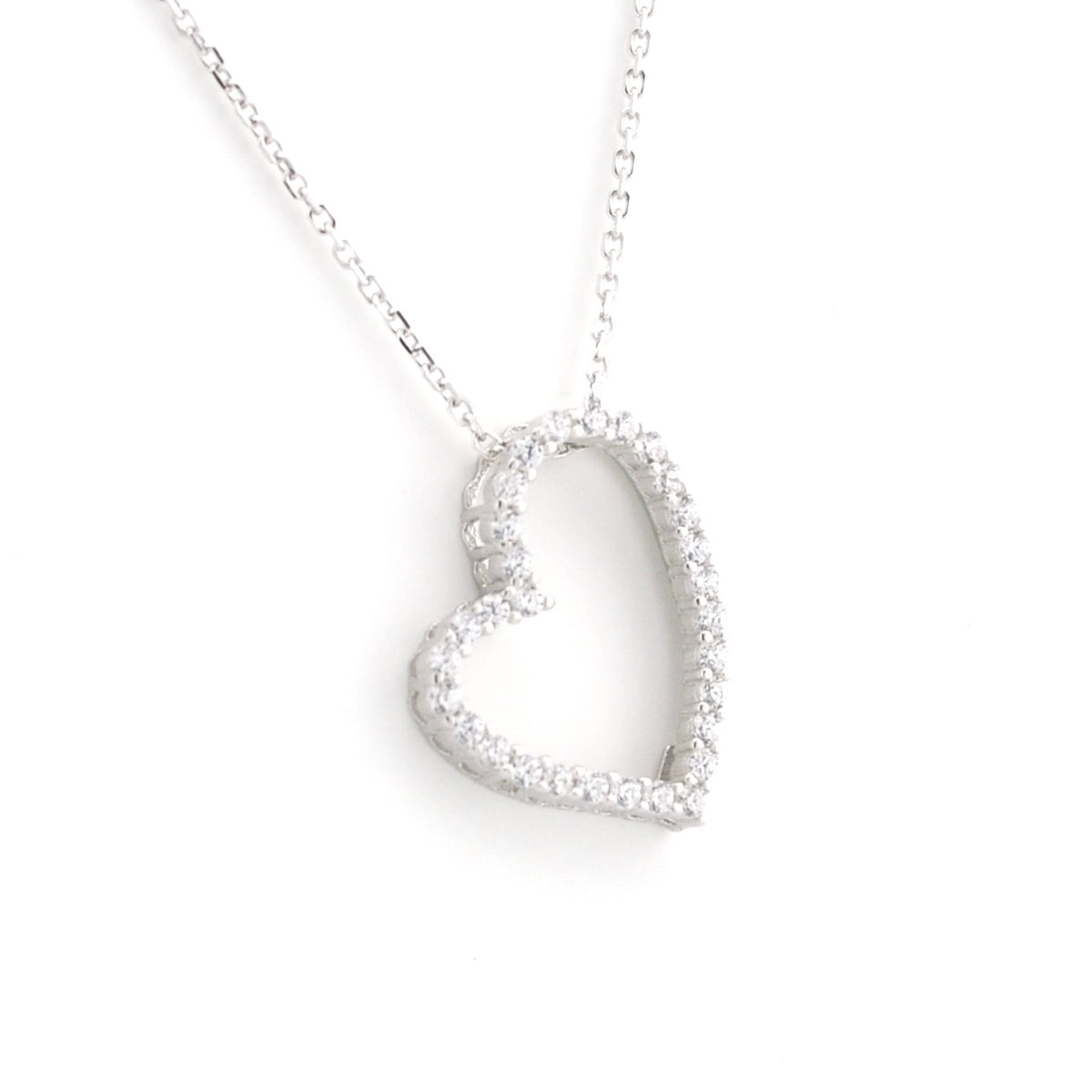 A silver heart-shaped pendant necklace adorned with small clear stones, suspended from a delicate silver chain against a plain white background.