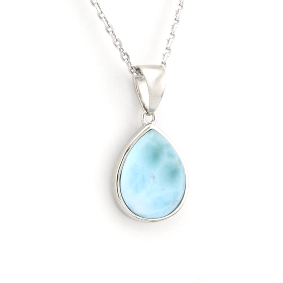 Teardrop-shaped larimar pendant on a silver chain against a white background