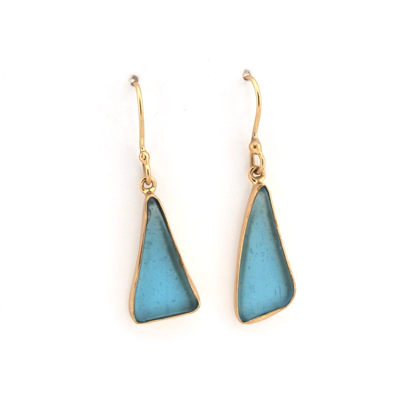 Pair of gold earrings with blue triangular stones on a white background