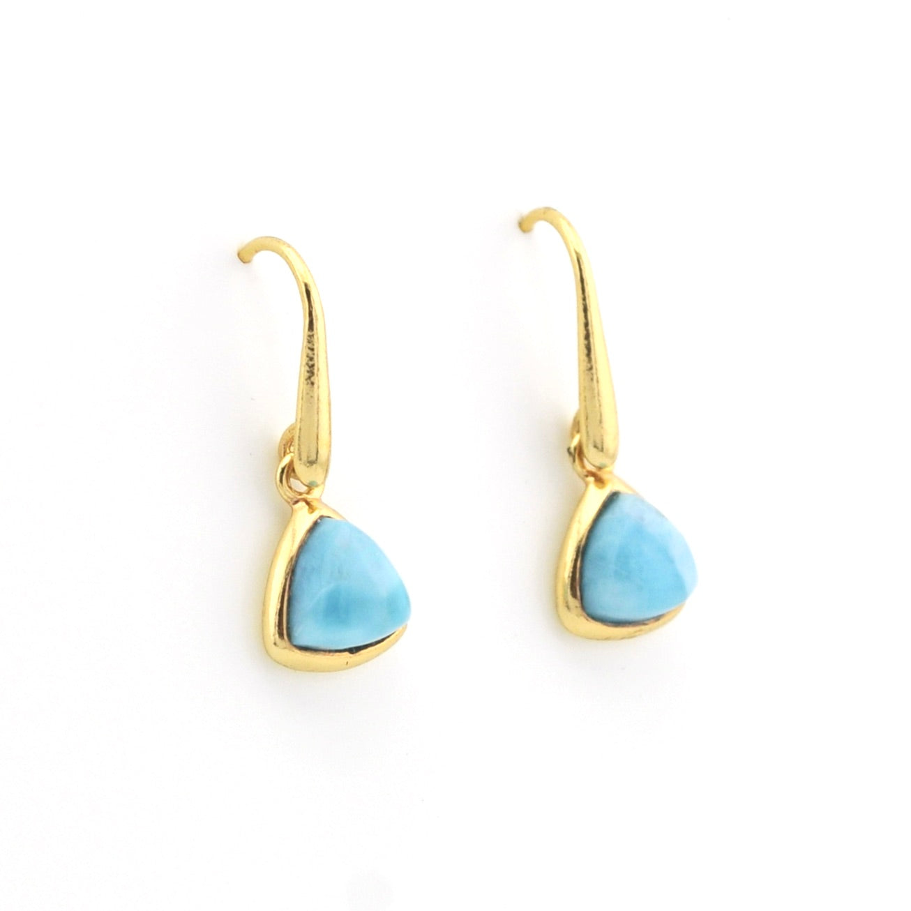 A pair of gold drop earrings with trillion-shaped light blue stone pendants, shown on a plain white background.