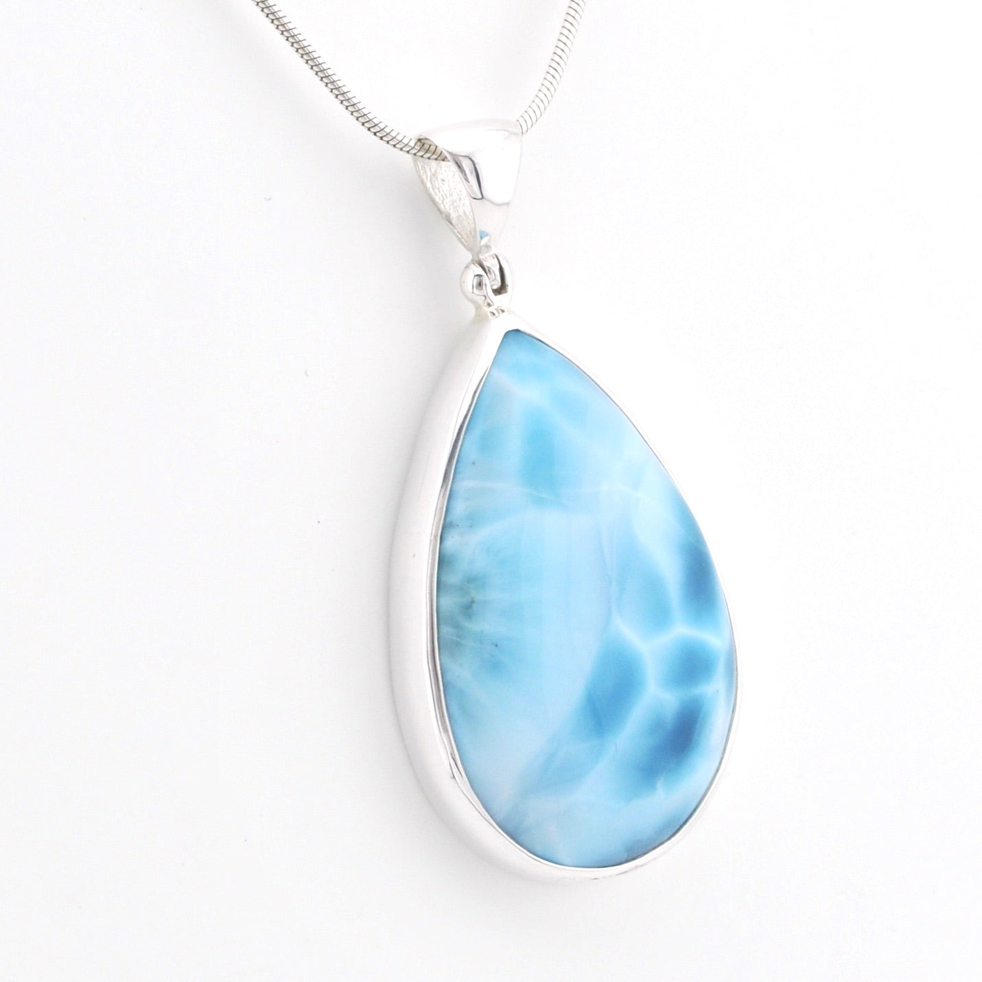 A teardrop-shaped Larimar pendant necklace in a silver bezel setting on a silver snake chain, shown against a plain white background.