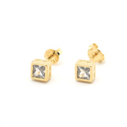 Gold square stud earrings with clear gemstones on a white background