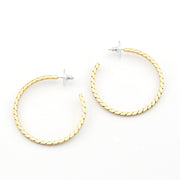 Gold hoop earrings on a white background