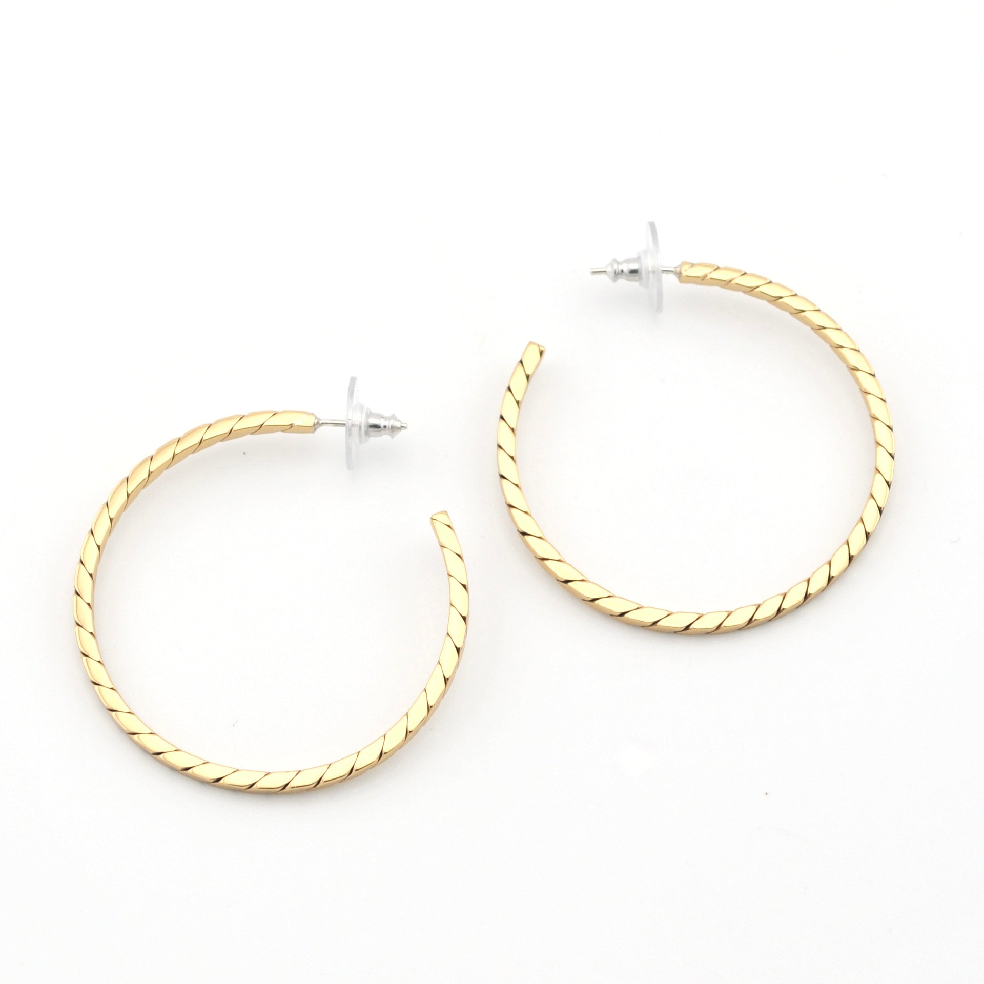 Gold hoop earrings on a white background