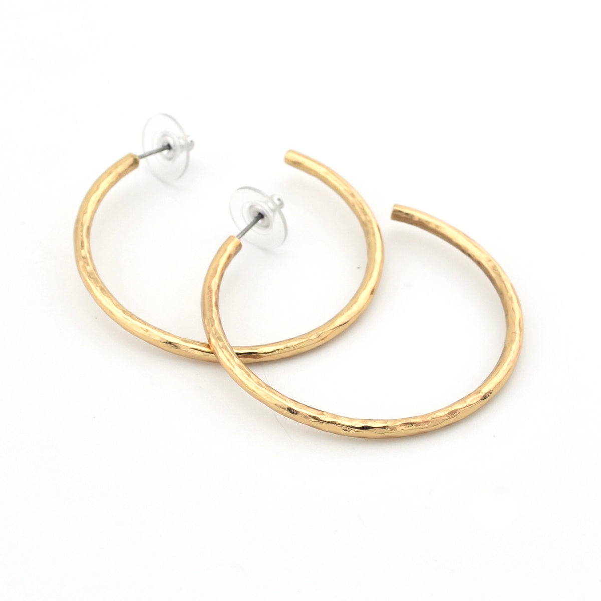 A pair of gold hoop earrings with a textured, hammered finish, shown on a plain white background.