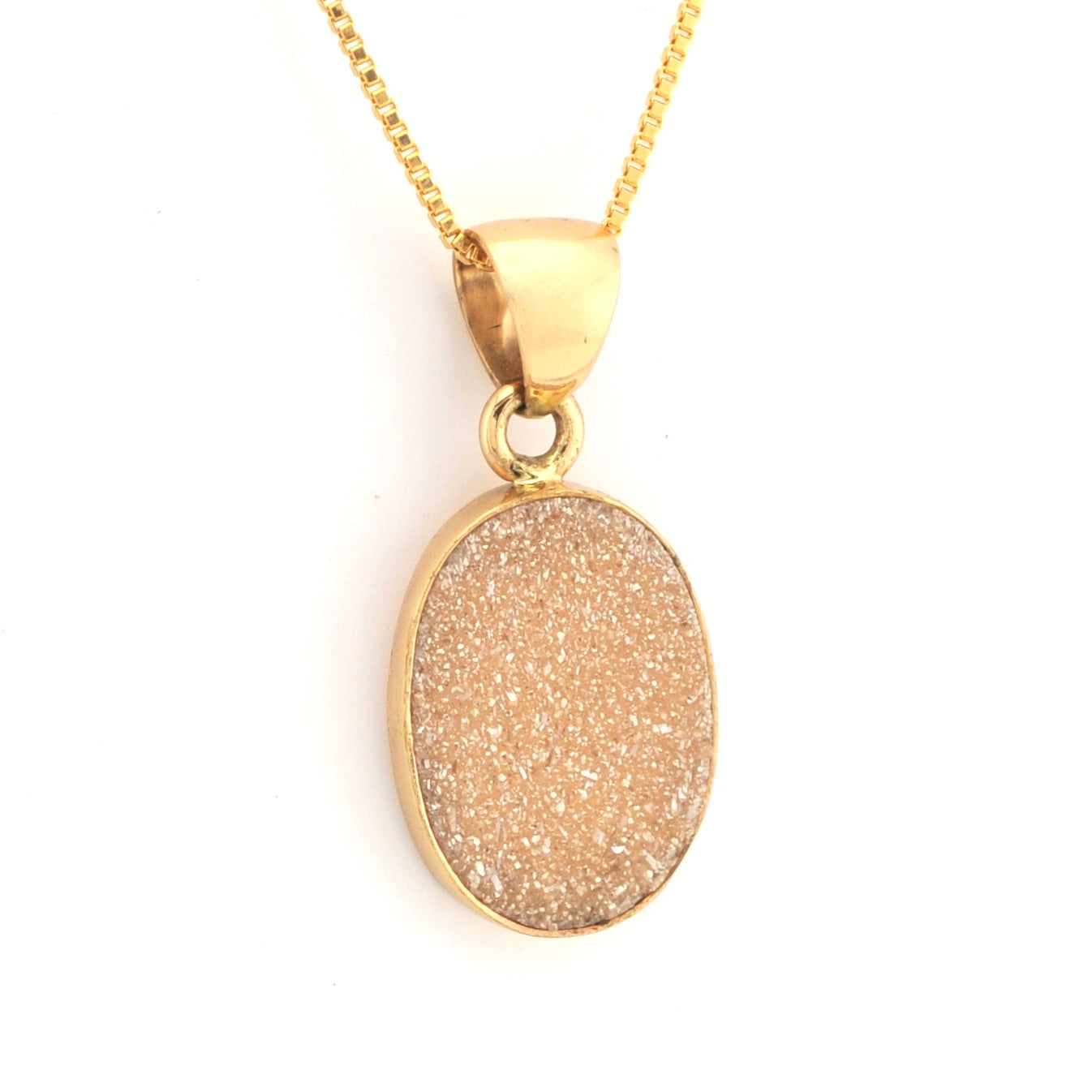 Gold necklace with a round, textured pendant on a white background