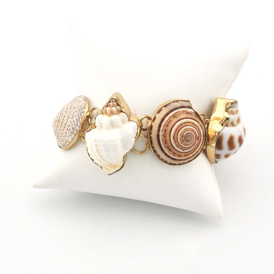 Bracelet with shell charms on a white stand
