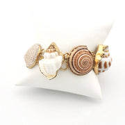 Bracelet with shell charms on a white stand