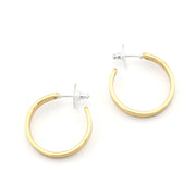 Gold hoop earrings on a white background