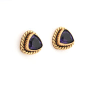 Pair of gold earrings with purple gemstones on a white background