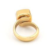 Gold ring with a unique design on a white background