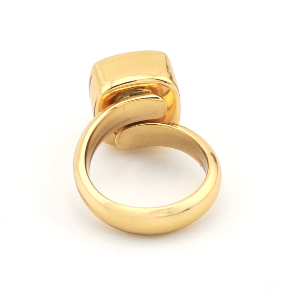 Gold ring with a unique design on a white background