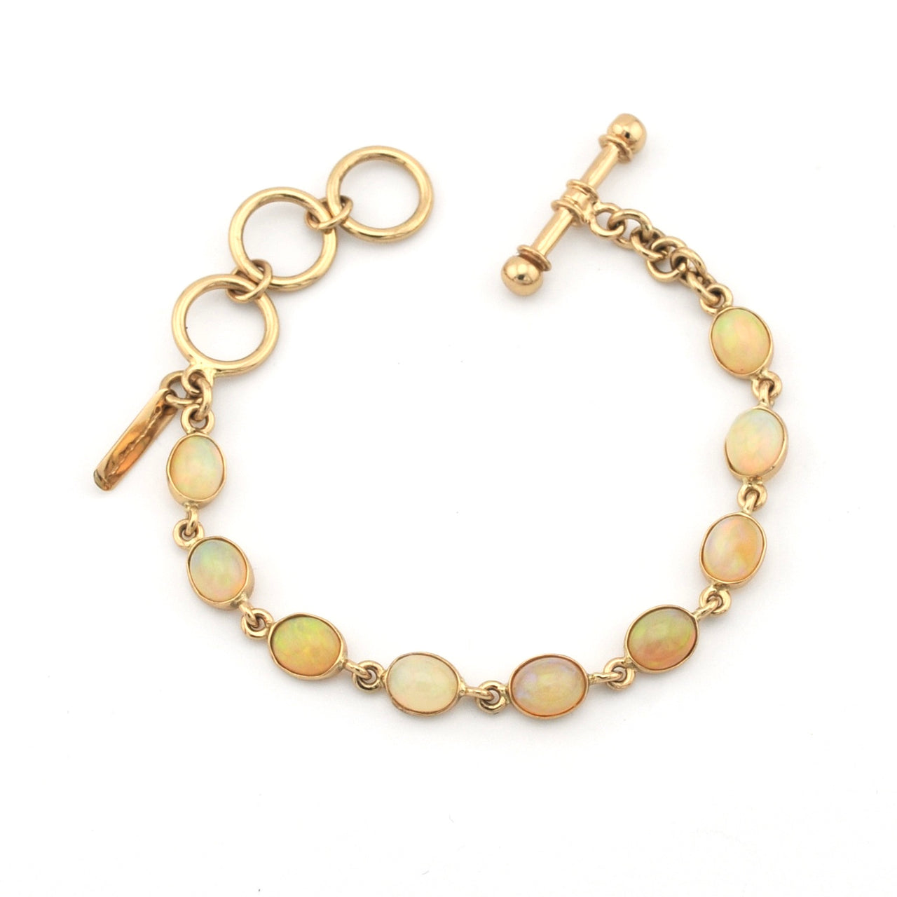 Gold bracelet with opal stones on a white background
