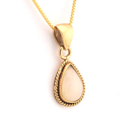 Gold pendant necklace with a teardrop-shaped white stone on a white background