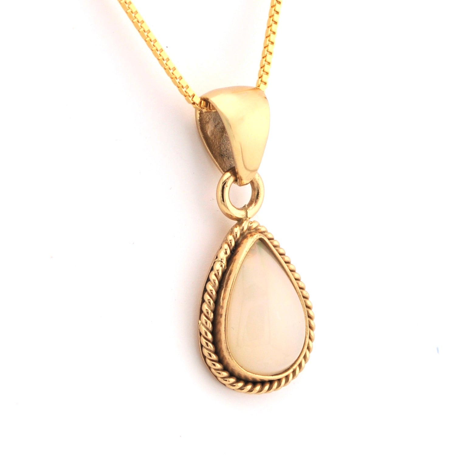 Gold pendant necklace with a teardrop-shaped white stone on a white background