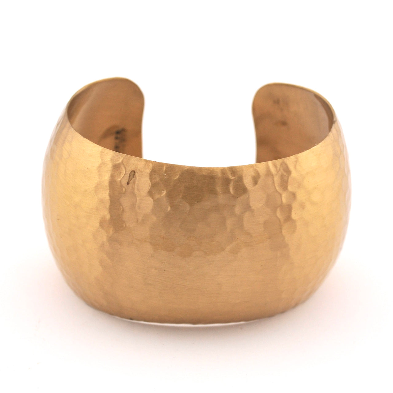 Gold cuff bracelet on a white background