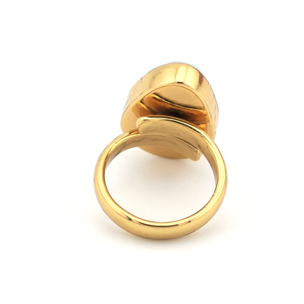 Gold ring with a unique design on a white background