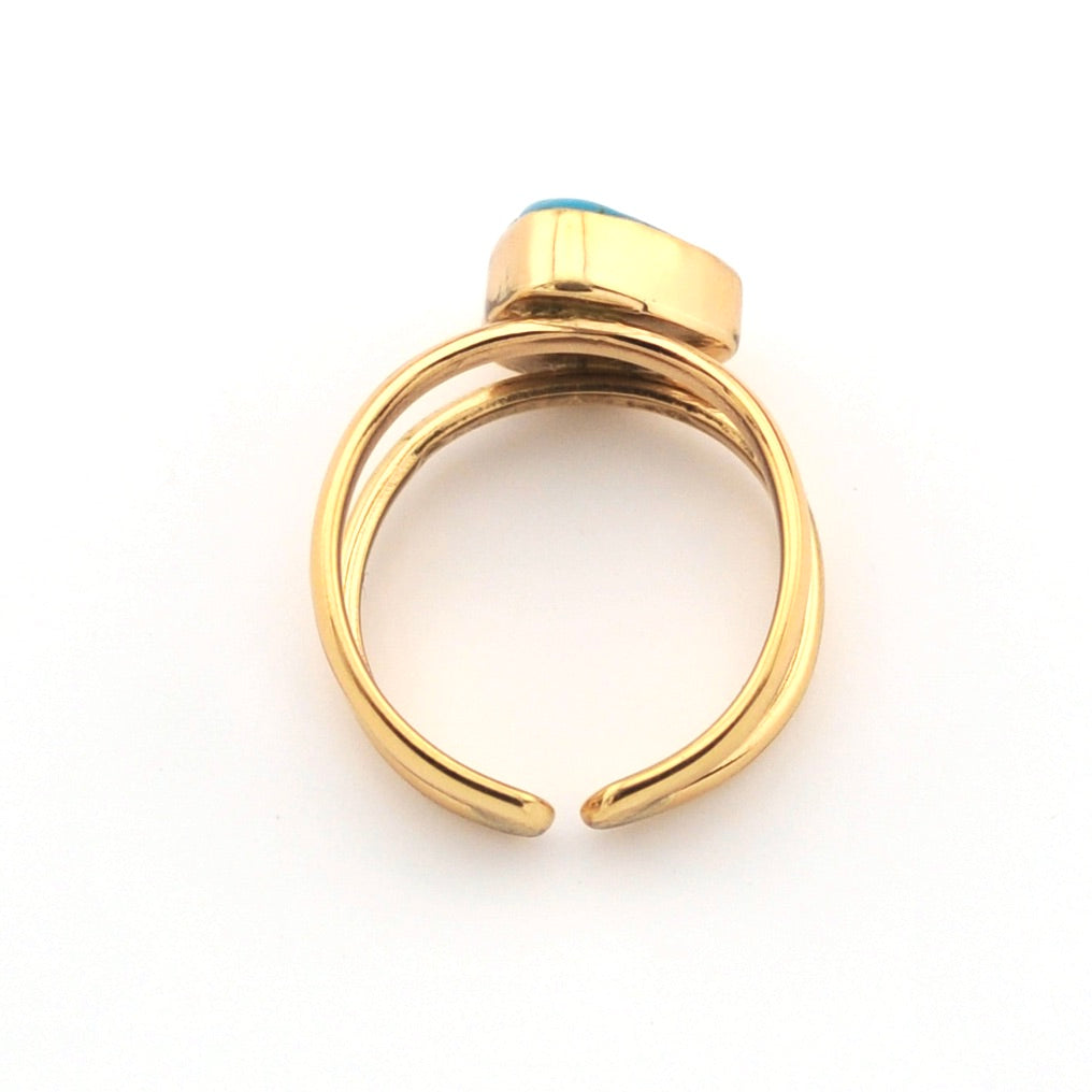 Gold ring with a blue stone on a white background