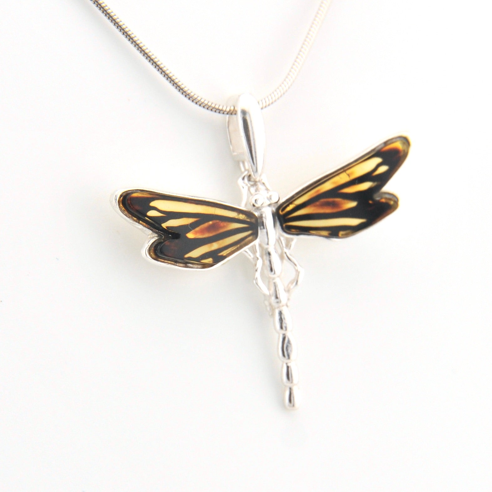 Dragonfly-shaped pendant on a white background