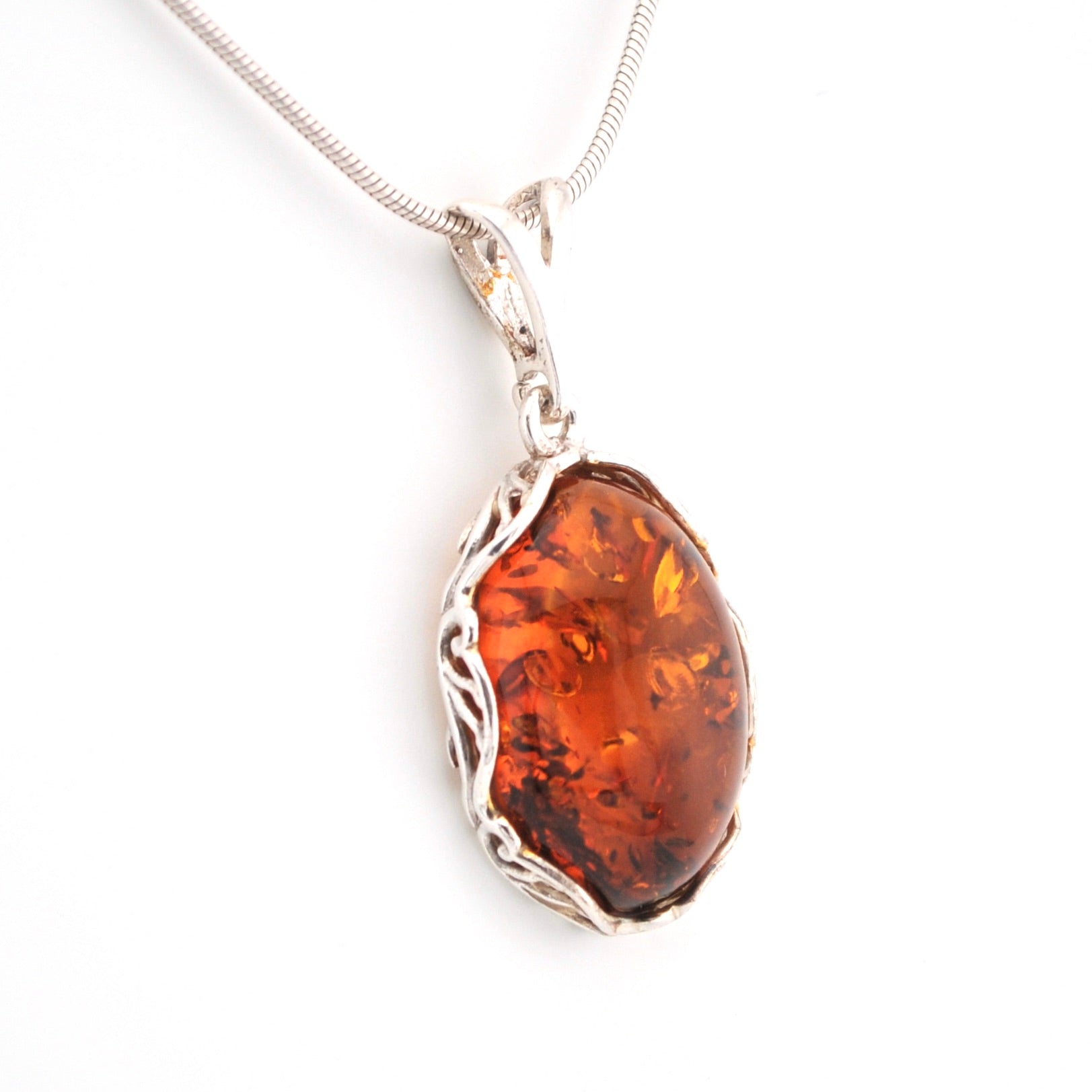 Amber pendant on a silver chain against a white background