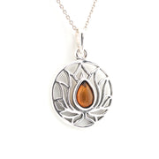 Silver pendant with a brown teardrop-shaped gemstone on a white background