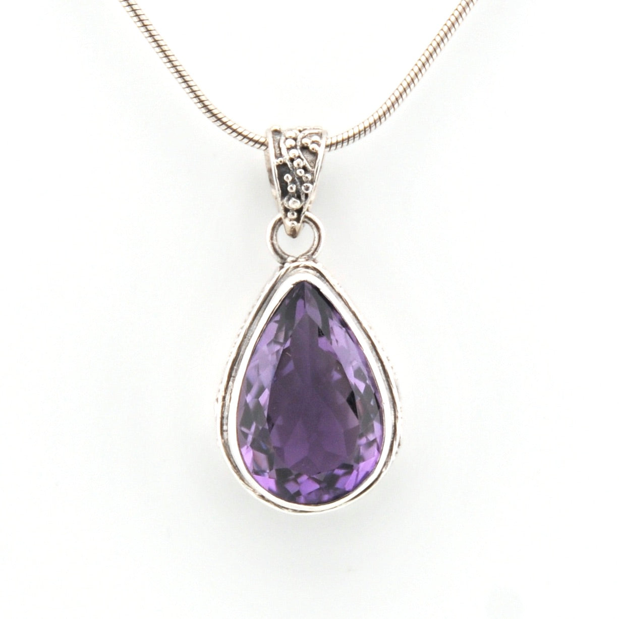 Purple teardrop pendant on a white background