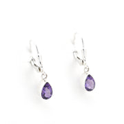 Pair of silver earrings with purple teardrop stones on a white background