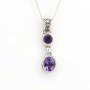 Silver necklace with two purple gemstones on a white background