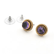 Pair of gold earrings with purple gemstones on a white background