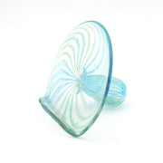 Glass object with blue and green swirl pattern on a white background