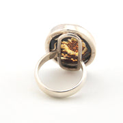 Silver ring with a sunflower design on a white background