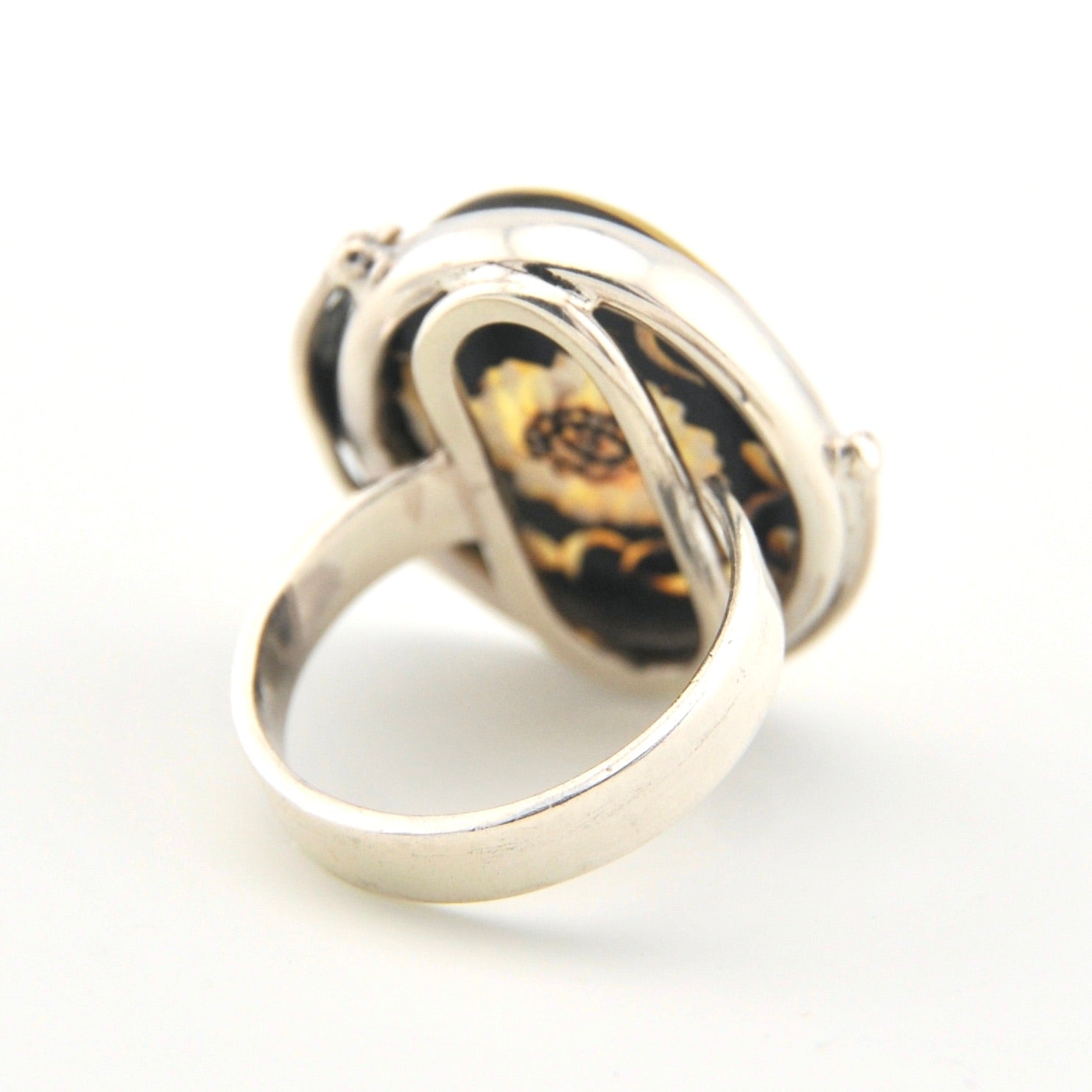 Silver ring with sunflower on a white background