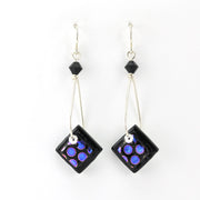 Pair of earrings with square purple and blue bead designs on a white background