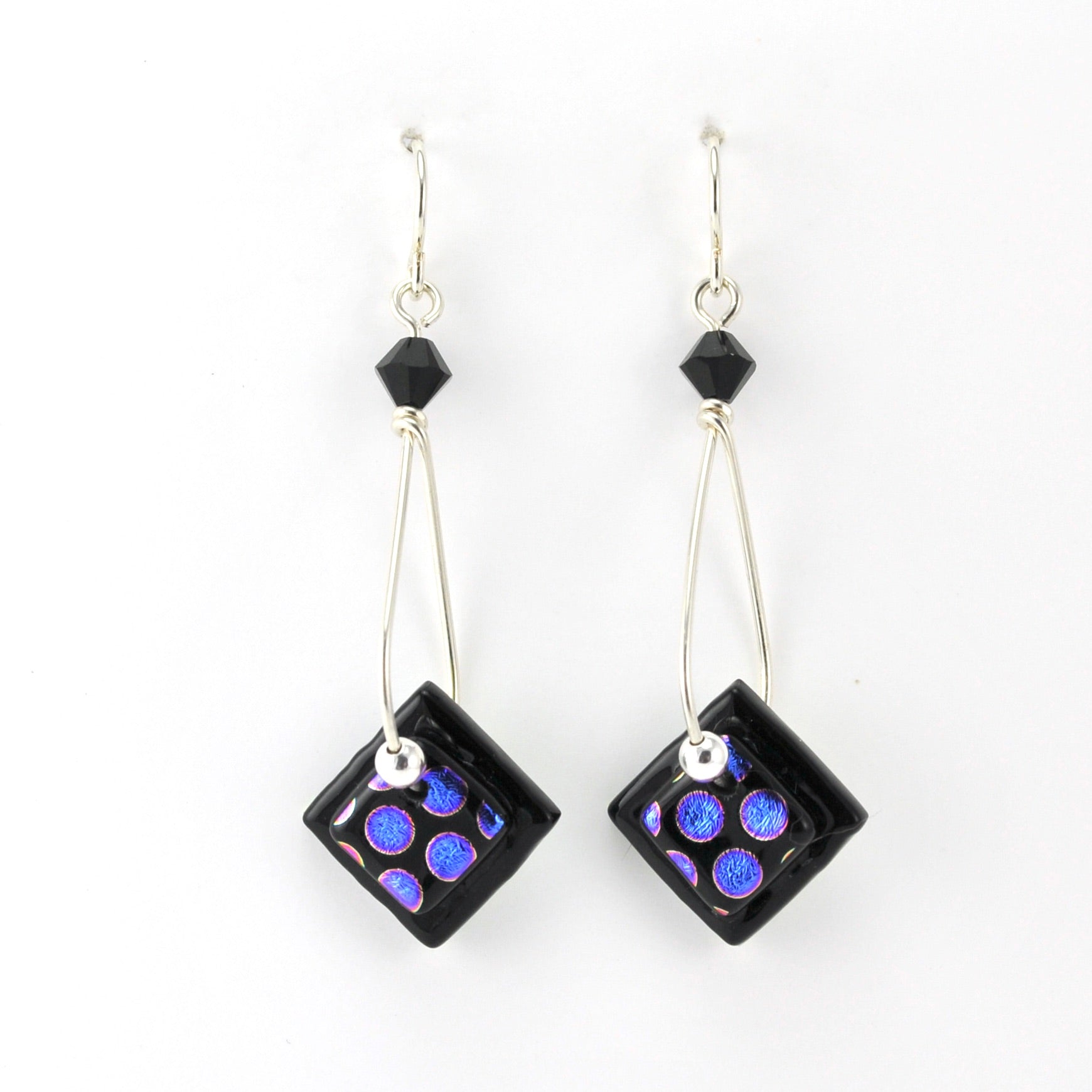 Pair of earrings with square purple and blue bead designs on a white background