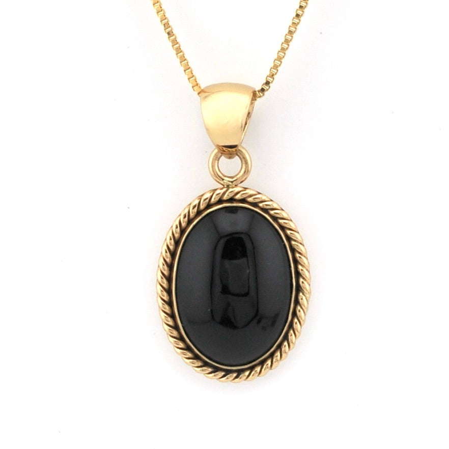 Gold necklace with a black pendant on a white background