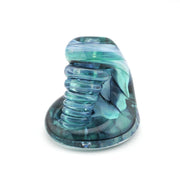 Glass candle holder with blue and green swirl design on a white background