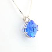 Blue crystal pendant on a white background