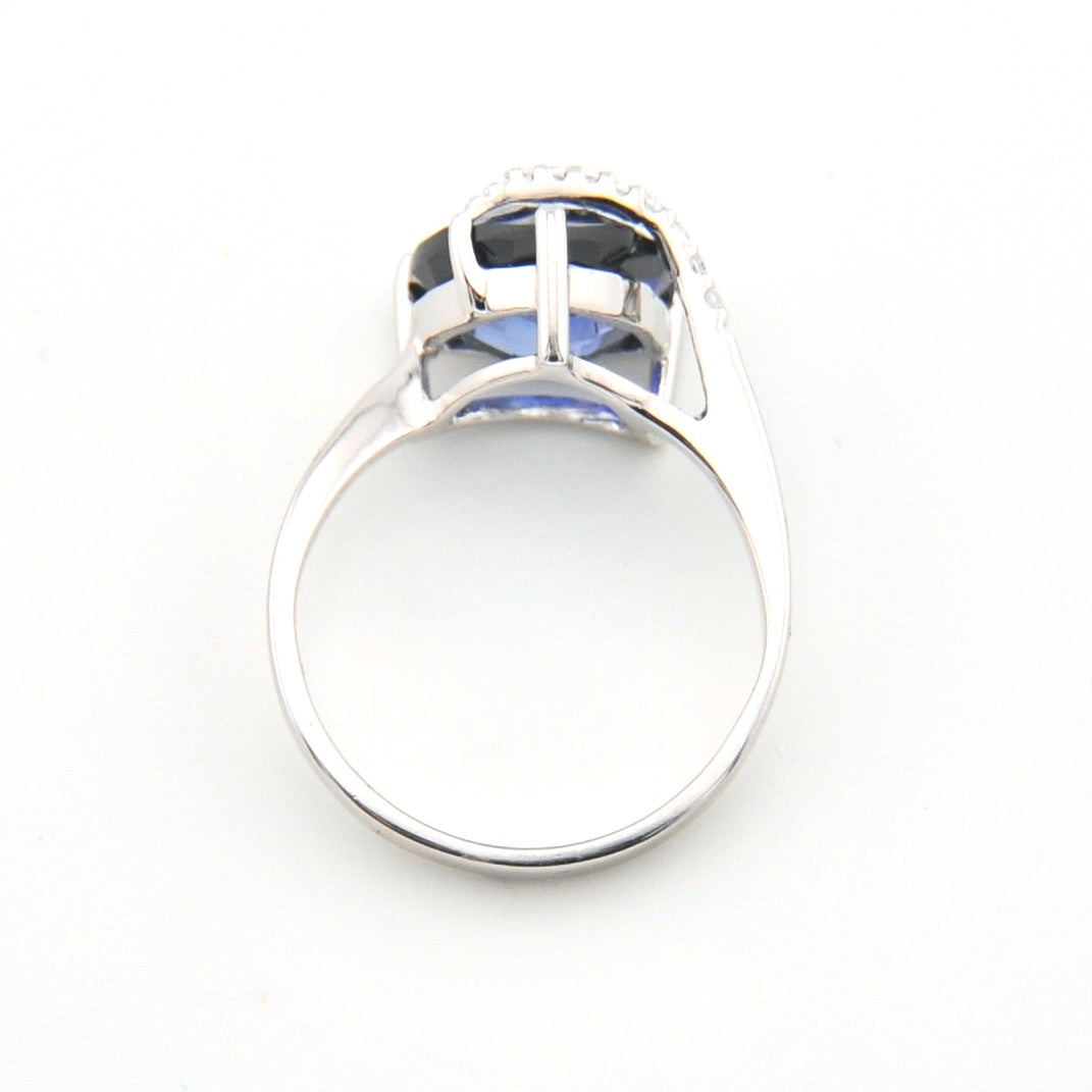 Silver ring with a clear gemstone on a white background