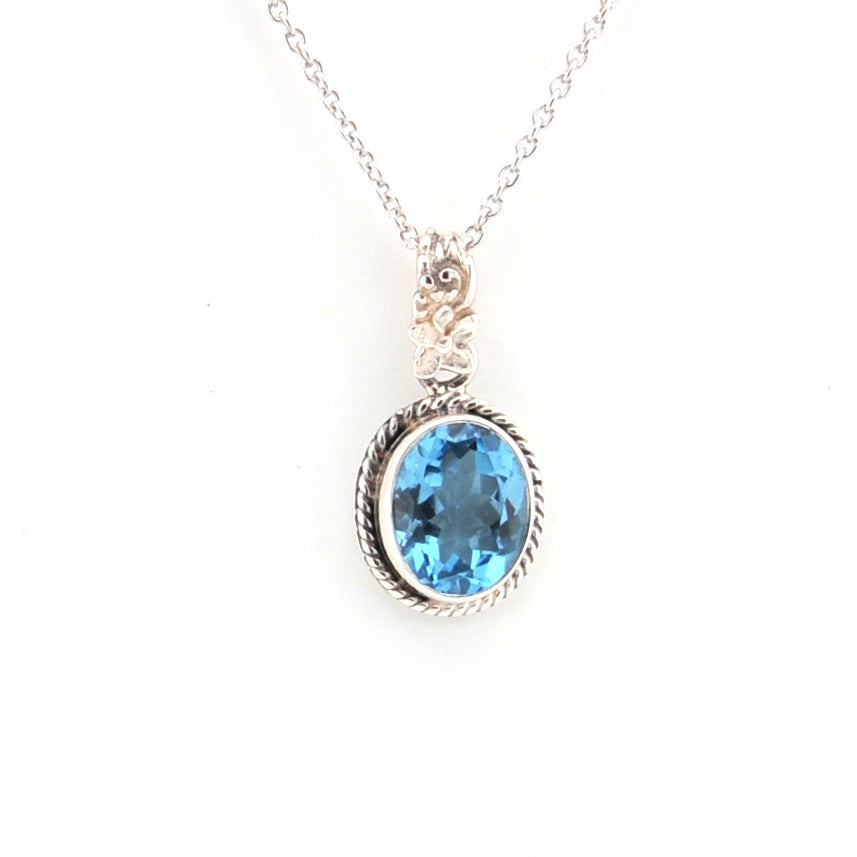 Silver necklace with a blue gemstone pendant on a white background