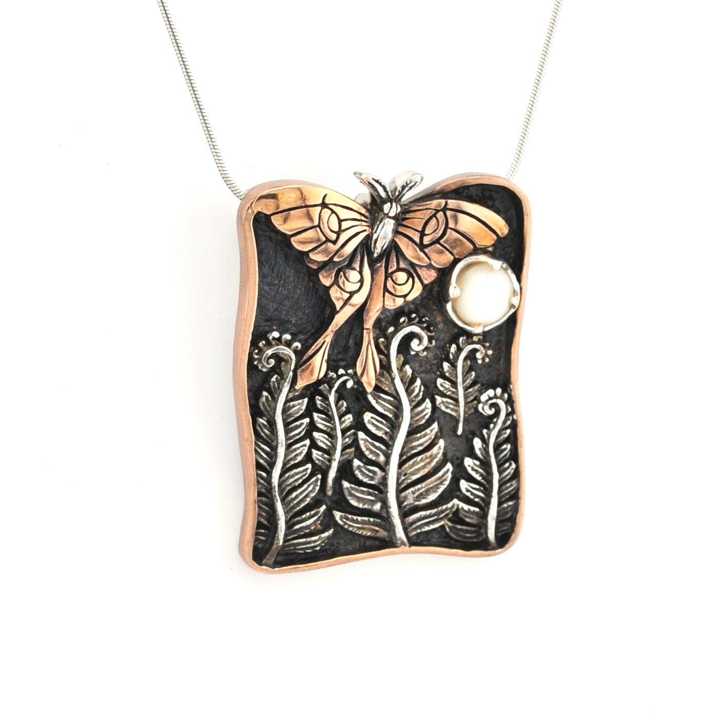 Necklace with a butterfly and leaf design pendant on a white background