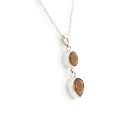 Silver necklace with two smoky quartz stones on a white background