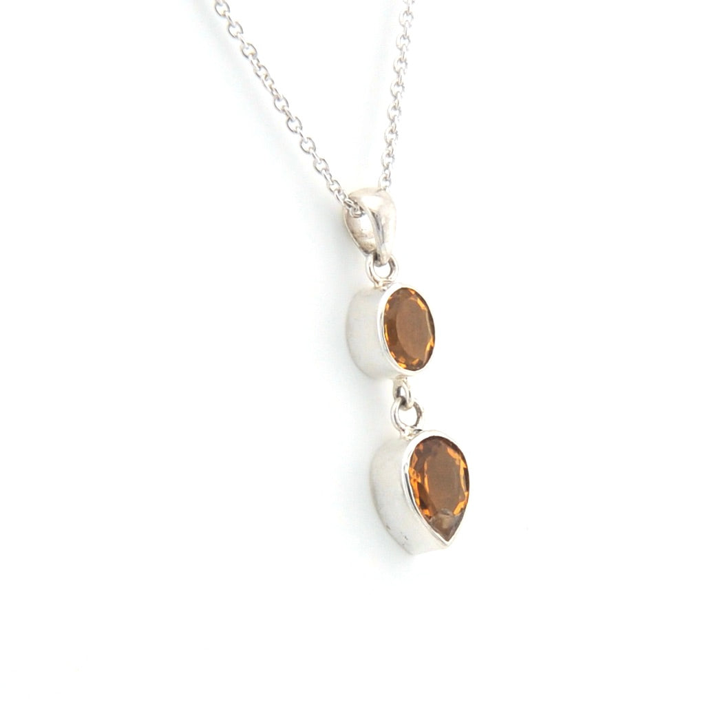 Silver necklace with two smoky quartz stones on a white background