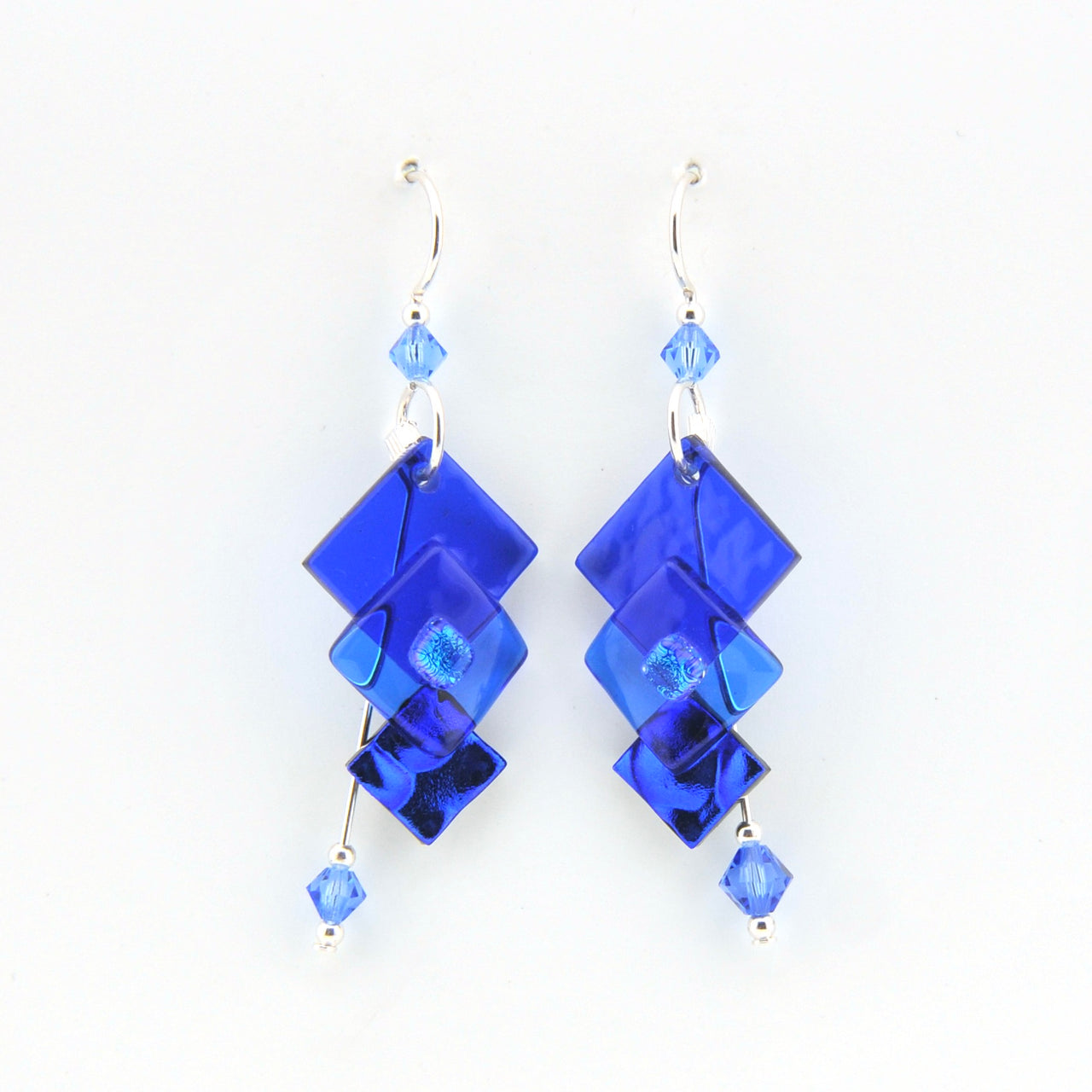 Blue geometric earrings on a white background