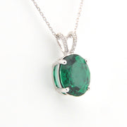 Green gemstone pendant on a white background